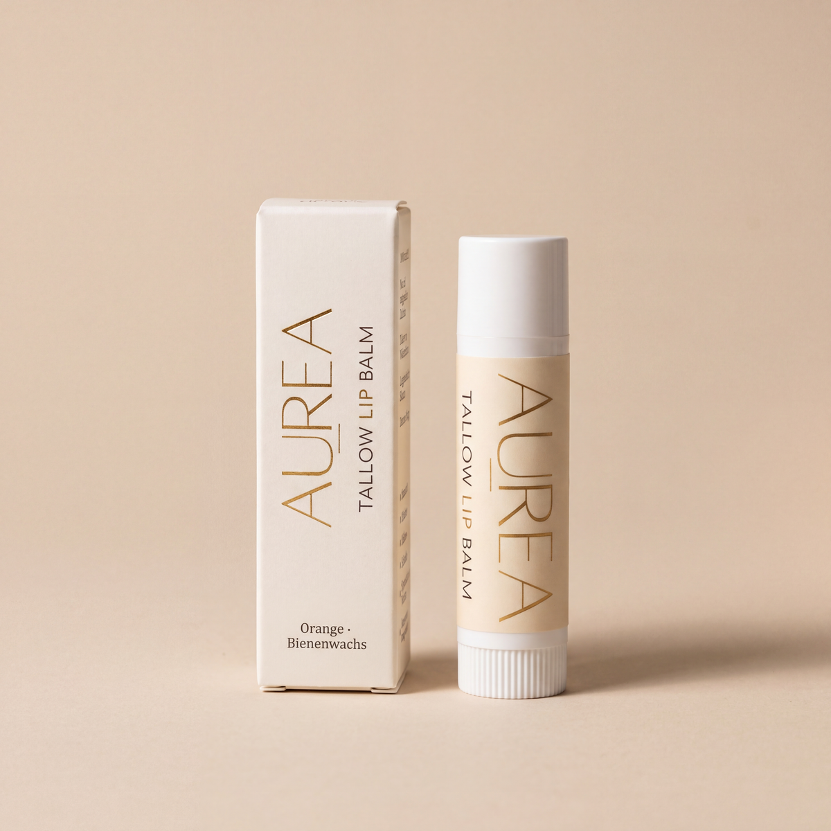 Aurea Tallow Lip Balm Stift neben seiner Verpackung