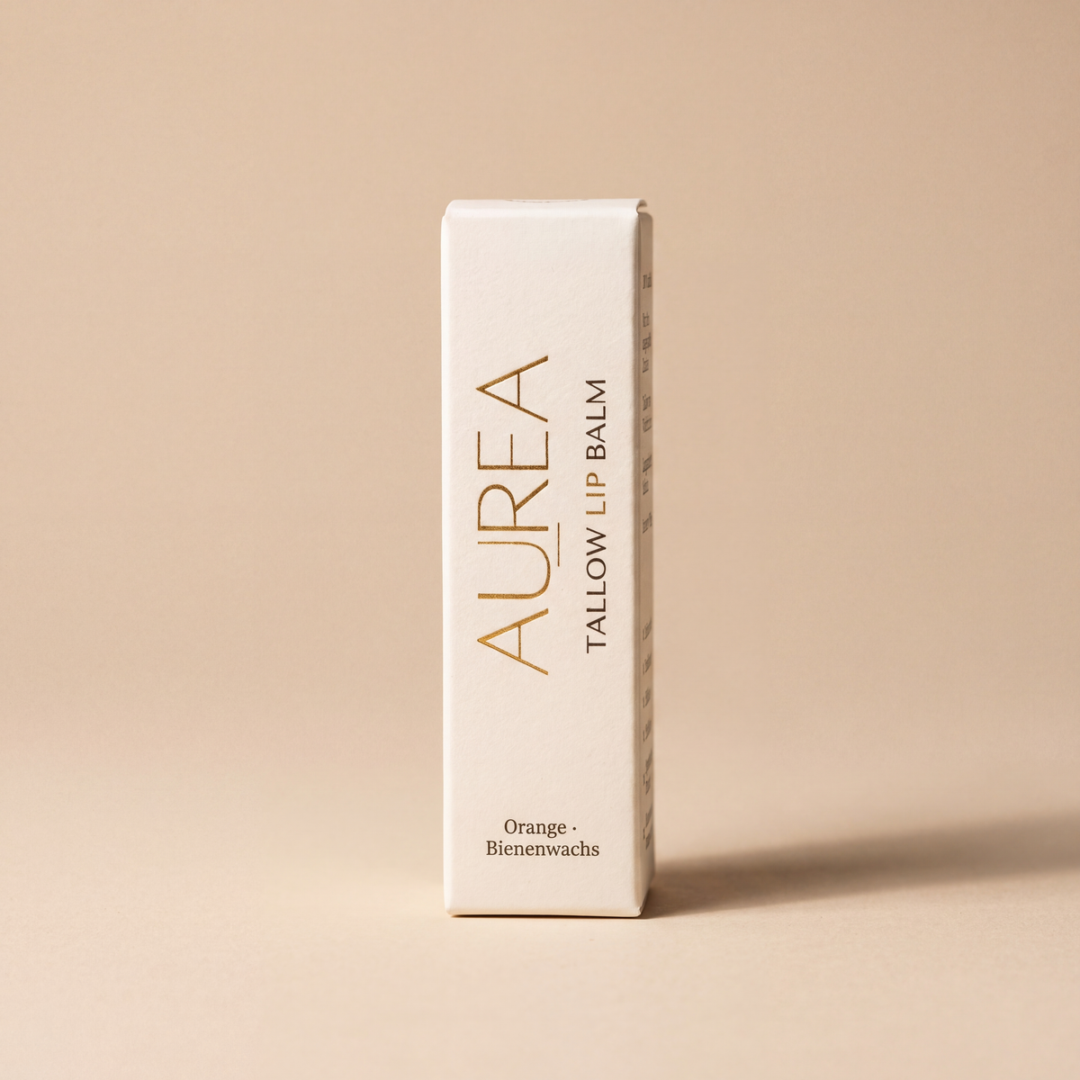 Verpackung des Aurea Tallow Lip Balm mit Orange und Bienenwachs